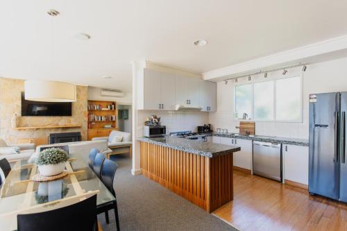 a kitchen with white cabinets and a blue refrigerator at Yarra Valley Grand in Yarra Glen