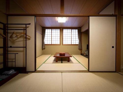 Postel nebo postele na pokoji v ubytování 河辺ふるさとの宿