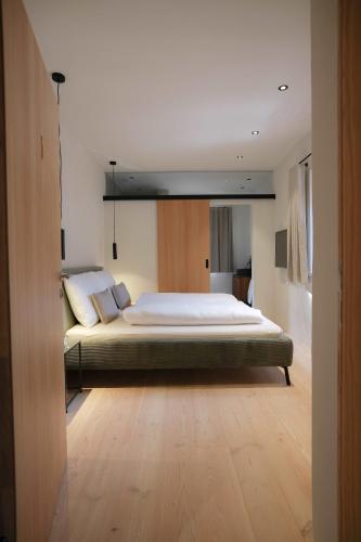 a bedroom with a large bed in a room at das 1494 Wohnen und Kultur im Denkmal in Mieming