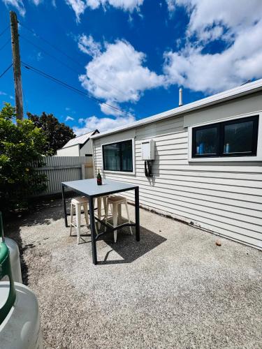 a table and chairs in front of a trailer at Modern 1 bedroom guest house in Upper Hutt