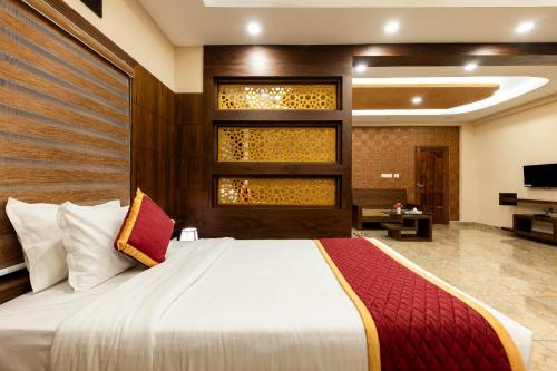 a bedroom with a large bed in a room at MARZA INN in Kalpetta