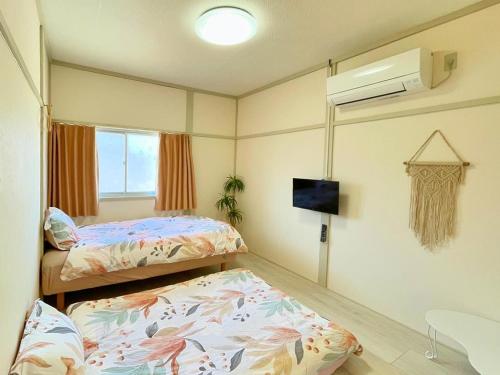 Postel nebo postele na pokoji v ubytování KOKOYUI GUESTHOUSE Taiji