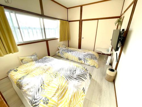 Postel nebo postele na pokoji v ubytování KOKOYUI GUESTHOUSE Taiji