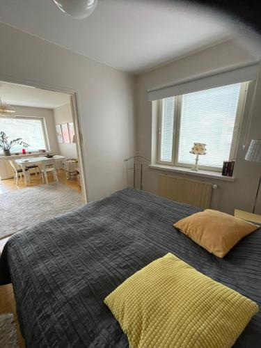 a bedroom with a large bed with a large window at Valimontien residenssi in Kouvola
