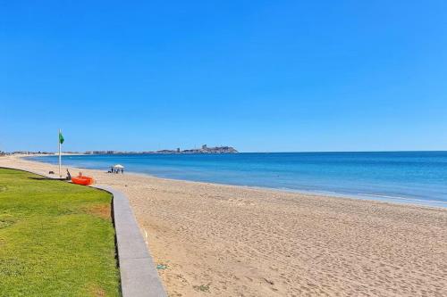 a sandy beach with a horse in the water at 301 C Princesa de peñasco in Puerto Peñasco