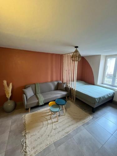a living room with a couch and two tables at Appartement frais et cosy idéalement situé in Nancy