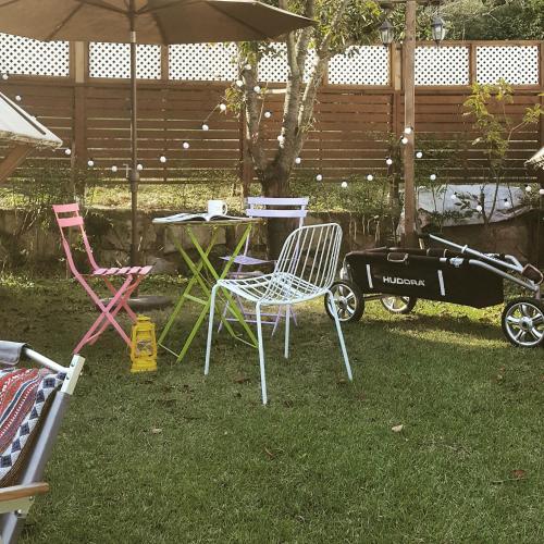 a table and chairs and a stroller in a yard at Adellia Pension in Gyeongju