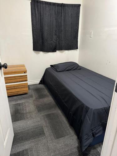 a small bedroom with a bed and a window at Cozy Routes at El Monte in El Monte