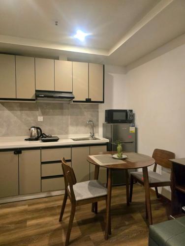 a kitchen and dining room with a table and chairs at Liam and Linus Condo 1 Studio Type in Baguio