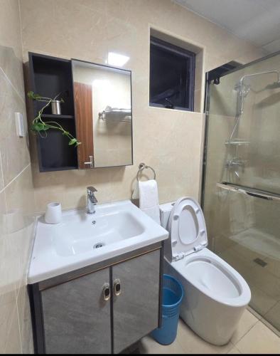a bathroom with a sink and a toilet and a shower at Liam and Linus Condo 1 Studio Type in Baguio