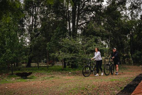 two women standing with their bikes in a park at Red Tail Retreat in Collie