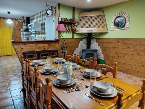 a wooden table with plates and utensils on it at El pony pisador in El Poyo