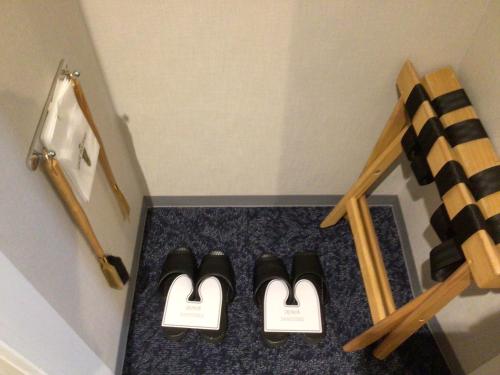 three pairs of shoes on a floor in a room at Hotel JAL City Aomori in Aomori