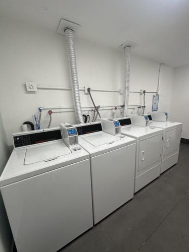 a row of white washing machines in a room at Cordova Arms By Rocketstay in Fort Lauderdale