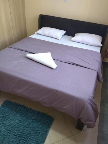 two beds with white pillows on top of them at Lee's Home in Thika