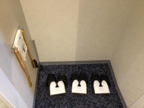 a row of black shoes on a counter in a room at Hotel JAL City Aomori in Aomori