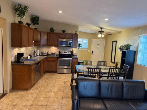 a kitchen with a couch and a table with chairs at 3 Bedroom, 2 Bath Whole House, Arizona State Univ, Tempe, Mesa Scottsdale on Light Rail, Dogs ok, Work Space in Mesa
