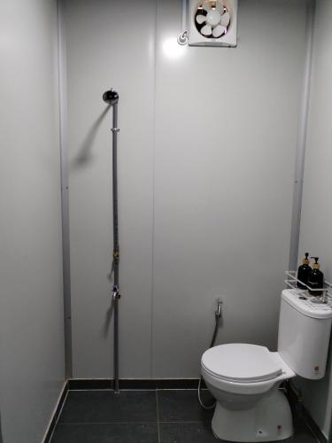 a bathroom with a white toilet in a room at The Vanilla Cabin 1 in Kampung Tok Jembal