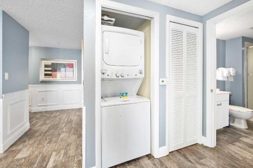 a white bathroom with a toilet and a window at Luxury 3BR Villa Wyndham Ocean Walk Resort in Daytona Beach