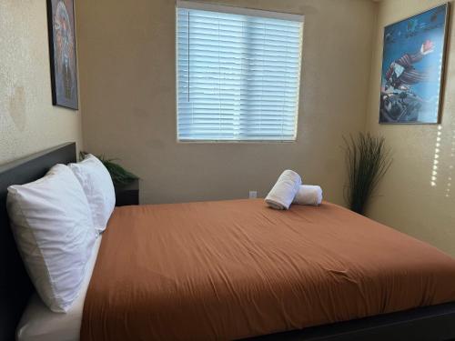 a bedroom with a bed with two pillows and a window at 3 Bedroom, 2 Bath Whole House, ASU, Tempe, Scottsdale on Light Rail in Mesa