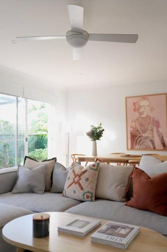 a living room with a couch and a table at Som House 2 in Shoal Bay