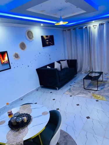 a living room with a couch and a table at GRANDE BnBs in Nanyuki