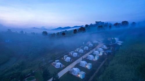 an aerial view of a train station in the fog at Florafreskhaokho in Khao Kho