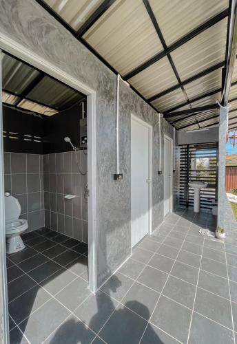 a bathroom with a shower and a toilet at Florafreskhaokho in Khao Kho