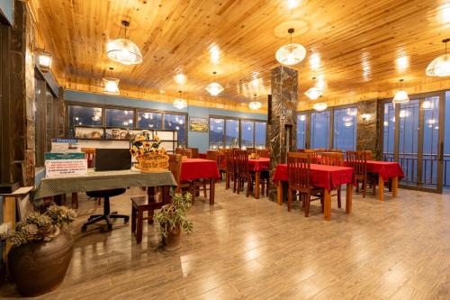 a dining room with red tables and chairs in a restaurant at Mường Hoa Hillside Homestay in Sa Pa