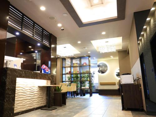 a restaurant with a counter and a dining room at RE Hotel Tanimachi9-2 in Osaka