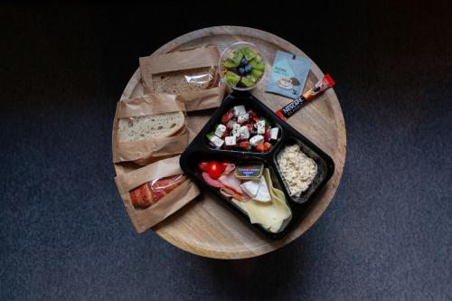 a plate with a tray of food on a table at Retro Apartmentments Łobzowska street in Kraków