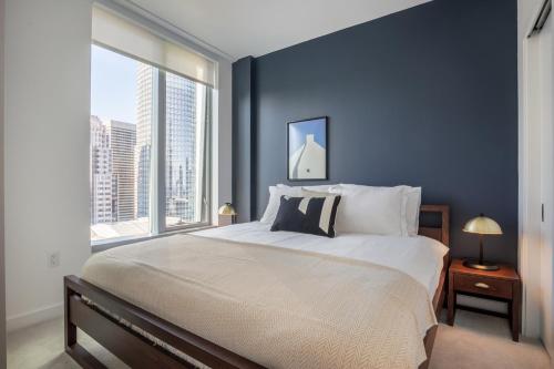 a bedroom with a large bed and a large window at Rincon Hill 1BR w Gym Steam Room nr SVB FB SFO-208 in San Francisco