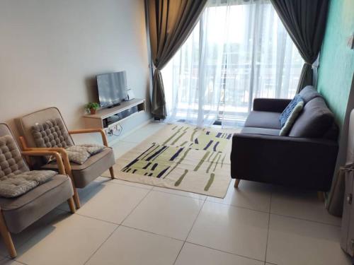 a living room with two chairs and a couch at The Horizon by MyKey in Ipoh