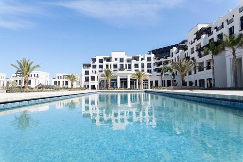 a large swimming pool in front of a building at Luxury Seaside Stay - SeaBreeze The Grand in Nardaran
