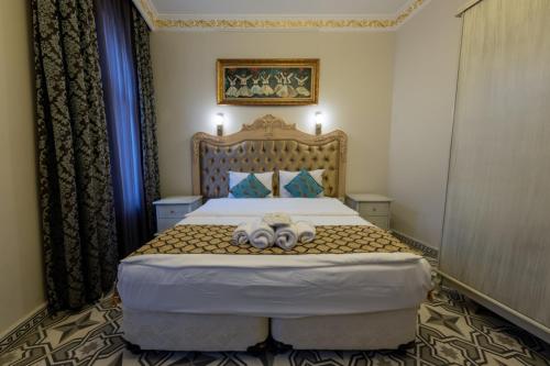 a bedroom with a bed with two teddy bears on it at Felicity Hotel İstanbul in Istanbul