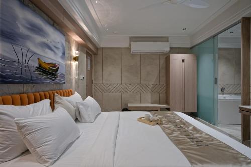 a bedroom with a large bed with white pillows at Golden Plaza in Ahmedabad