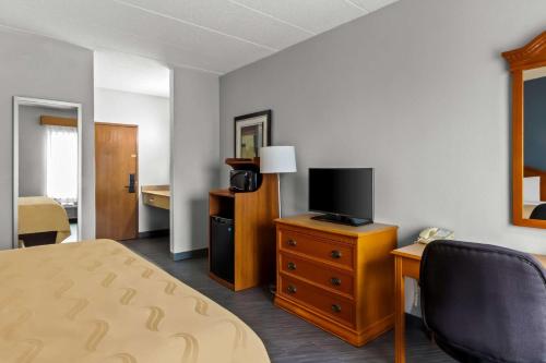a hotel room with a bed and a television at Quality Inn & Suites CVG Airport in Erlanger