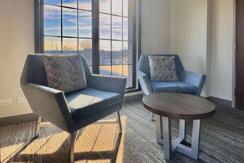 a waiting room with two chairs and a table at Sleep Inn Oakbrook Terrace - Chicago in Oakbrook Terrace