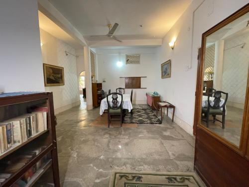 a living room with a table and chairs in it at The timeless Haven Heritage bungalow in Guwahati