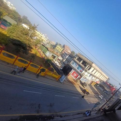 a view of a street with a yellow bus at Deivith Homestay Suite in Jowai