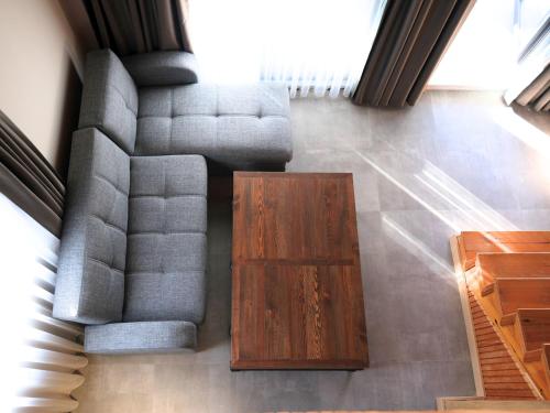 a living room with a couch and a coffee table at Perast Garden Hotel in Cıralı