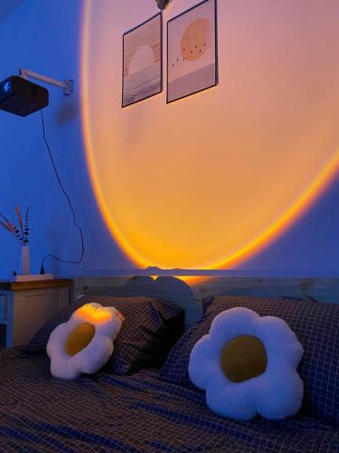 a bedroom with two stuffed animals on a bed at Cozynest Homestay n Cinema in Ho Chi Minh City