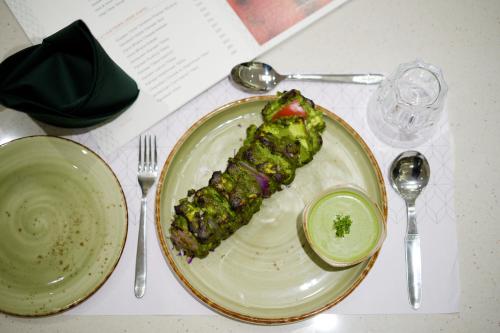 a plate with a piece of food on a table at Golden Plaza in Ahmedabad