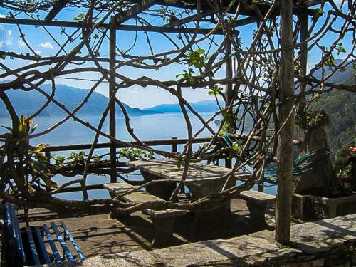a view of a body of water with a bench at Il Pergolato in Cannero Riviera