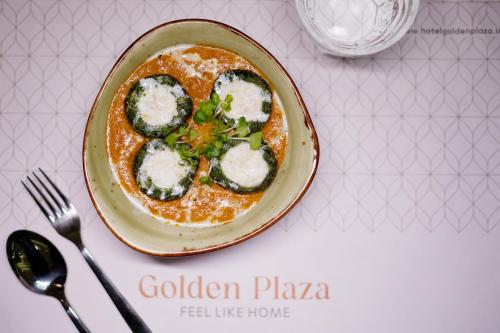 a plate of food sitting on a table at Golden Plaza in Ahmedabad