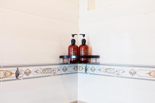 two bottles of alcohol sitting on a shelf in a kitchen at Blue Diamond Homestay in Ấp Bình Phú