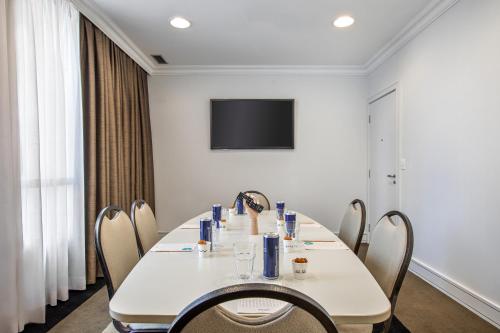 a conference room with a white table and chairs at INNSiDE by Meliá São Paulo Iguatemi in Sao Paulo