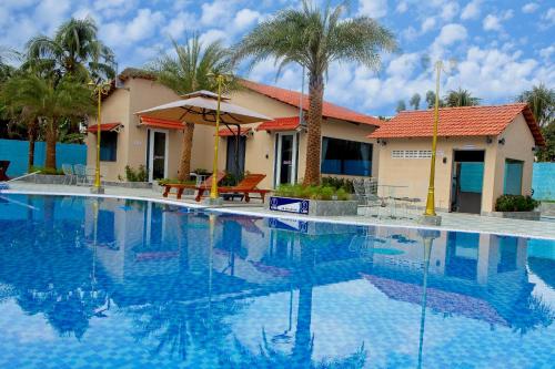 a large swimming pool in front of a house at Blue Diamond Homestay in Ấp Bình Phú