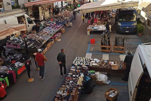 an overhead view of a market with people walking around tables at Antonio's apartment in the historic center in Castelnuovo di Garfagnana