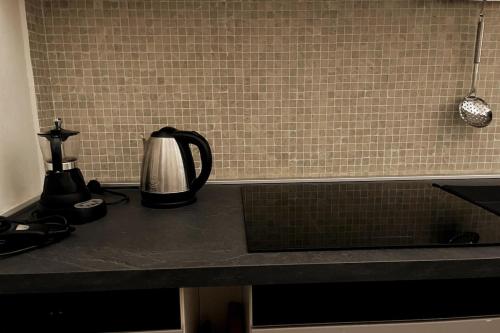 a kitchen counter with a coffee maker on it at Antonio's apartment in the historic center in Castelnuovo di Garfagnana
